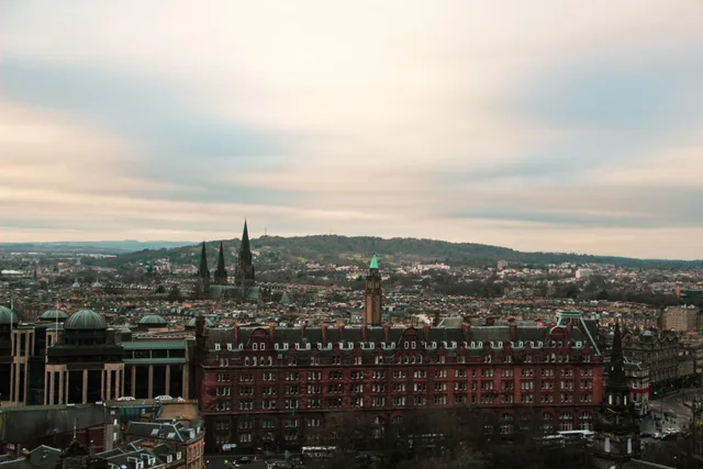 Aerial view of Edinburgh showcasing its historic architecture under a cloudy sky. Edinburgh and Glasgow creator taxes: Scottish income tax bands